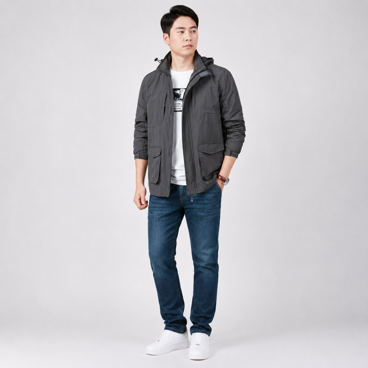 Man wearing a lightweight hooded jacket in gray