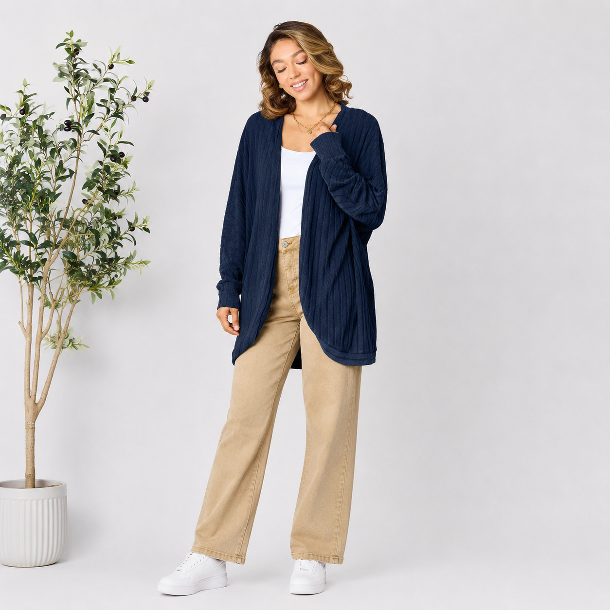 Full-length view of a women's ribbed cardigan outfit