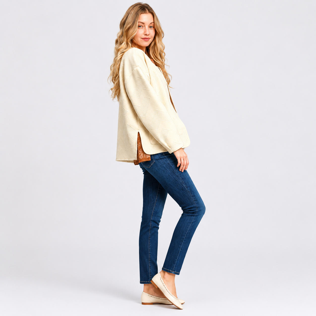 Women's cream textured jacket styled with blue jeans